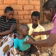 Senior CHW visiting a family in Malawi