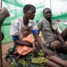 Ruth Lazo sleeps outside at Somo camp with Piriran Seza and their 4-month-old daughter, Alufa Lazo. PIH provides clinical care for Cyclone Freddy survivors.
