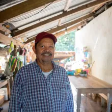 A close-up portrait of Carlos Vasquez, showing his face in detail with a smile. 