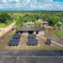 Image of 5 large solar panels in a rural village in Peru