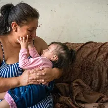 Leidith Tinoco cradles her daughter. 