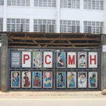 Pedestrians pass the entrance to Princess Christian Maternity Hospital in Freetown, Sierra Leone