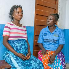 Gladys Abu, a traditional birth attendant, right, accompanies   expecting mother Mary Senesie to Bumpe Community Health Post for an appointment.