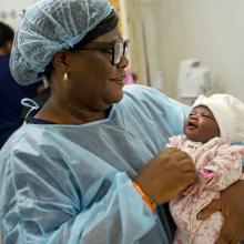 Sister Patricia Efe Azikiwe, holds Sia Fengai’s newborn baby shortly after birth