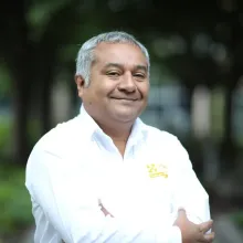 Doctor standing in white lab coat with arms crossed