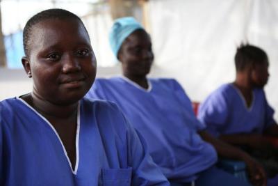 Three women in blue scrubs