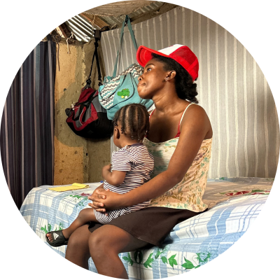 Naïka Morin and her son look toward her social worker, Clifford Merisma, just out of frame.