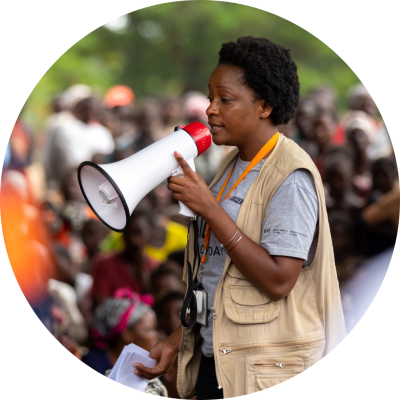 Rachel Mwanza, Adolescent and Women’s Health Clinical Mentor at APZU, addresses a crowd at the Mitondo cyclone camp on April 1, 2023.