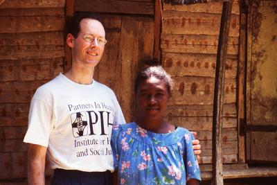 Dr. Paul Farmer standing with a patient.