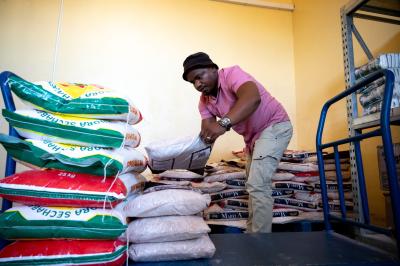 Ntate Malefetsane prepares the food packages in the warehouse