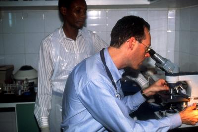 Dr. Paul farmer looks through a telescope.