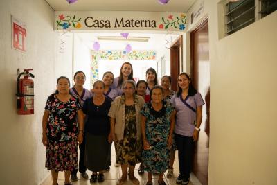 Compañeros En Salud staff stand with traditional midwives in the new Casa Materna