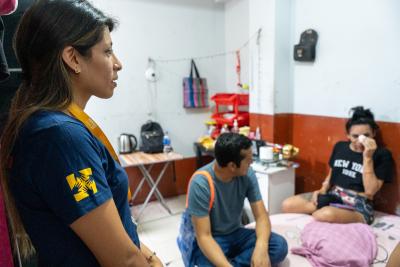 Carla Rodríguez (left) and her colleagues meet with Daniela, a transgender woman who receives care and support from SES.