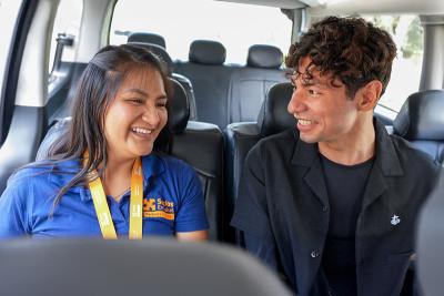 Kioshi Vásquez with Betsabe Roman, SES TB program specialist, driving to one of his appointments.