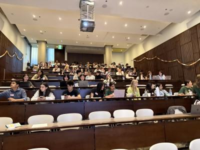 In a University of Toronto auditorium, students sit in rows.