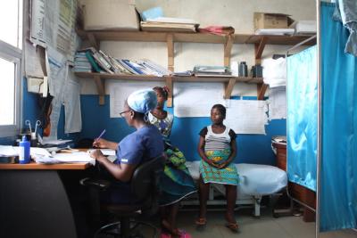 Midwife taking notes with patient