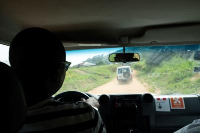 Man driving behind a van