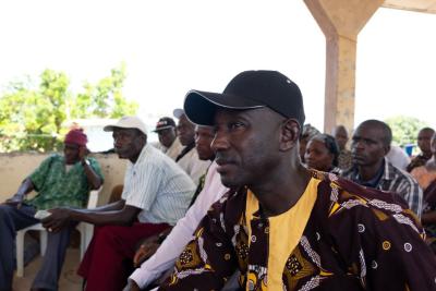 A resident of Soa Chiefdom listens to the presentations.