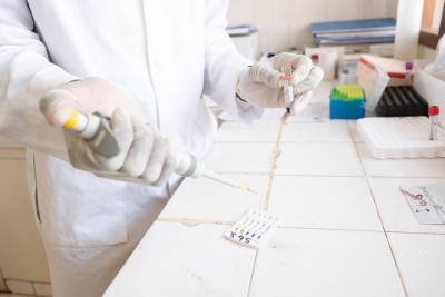 A laboratory technician conducts a blood test for hepatitis B