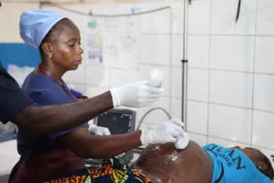 Midwife performs an ultrasound on a patient