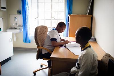 Doctor examines patient in Lesotho.