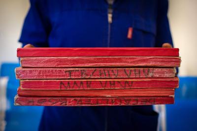 village health worker coordinator at Mapheleng Health Center in Berea District, Lesotho holding notebooks
