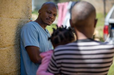 Marumo speaks with Mokone’s family outside. 