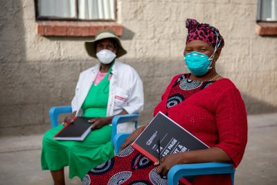 Treatment supporter trainees Mamonyane Ramotlou and Mamolantoa Letlisa sit together at the halfway house.