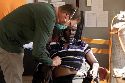Dr. Ryan Meili, visiting doctor and PIH Canada board member, examines Qacha Qabane during an appointment at Nkau Health Center in Mohale's Hoek District, Lesotho. 