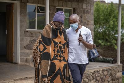 Khanyapa Tuoane receives TB medication at Thlanyaku Health Centre with support from PIH nurse Molefi Tsiu.