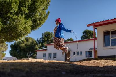 At nine months pregnant, Mabatho Selai jumps rope outside the PIH-supported Nkau Health Center in Lesotho.