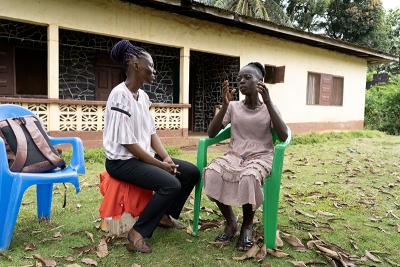 Naewah T. Bemian (left), a member of PIH Liberia's community health team, during a follow-up visit with Patience N. Toe.