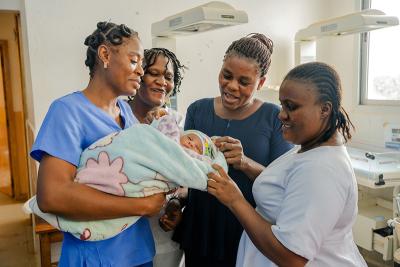 Labor and delivery ward staff, from left, Munie Clark, Linda Freeman, Elizabeth Y. Allison, and Decontee D. Assic gather around newborn Adolphus Wesseh.
