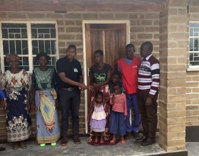 Mother holding her children, gets a new home