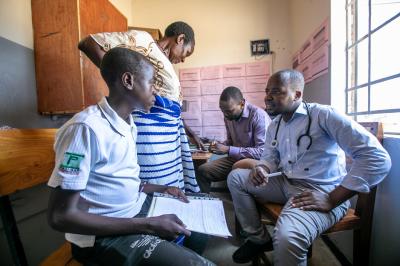 Doctor feeling a patient's chest for breathing
