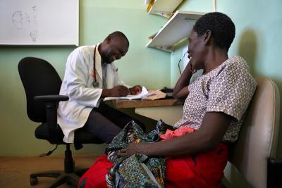 Medson Boti, a clinical officer, conducting a check-up on Vitalina Chaona at Neno District Hospital in Malawi.
