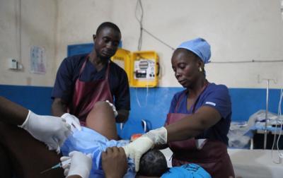 Midwives helping in labour