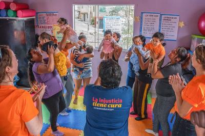 Mothers and their children meet for an educational session