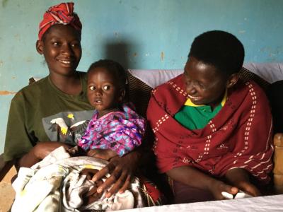 Françoise Umutesi enjoys a moment with her grandson, 1-year-old Blessing