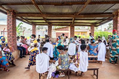 Patients sit in a waiting area for appointments ranging from screening for non-communicable diseases to immunizations for babies.