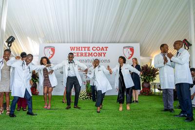 UGHE's third cohort of Bachelor of Medicine, Bachelor of Surgery students celebrate after receiving their white coats during a ceremony in Butaro, Rwanda.