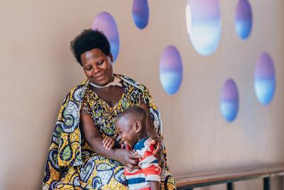 Valentine Mukandebe, a mother of four, and her youngest son, Felicien, who was born with a disability, share a moment of joy for the progress they’ve made together. 