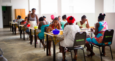 Women staying at Kay Manmito sharing a meal