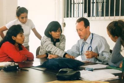 Dr. Paul Farmer reviews documents with a group.