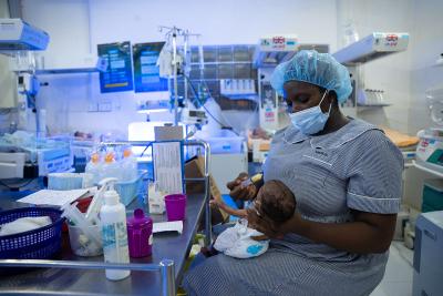 A staff member at the Special Care Baby Unit at KGH feeds a newborn in the unit.