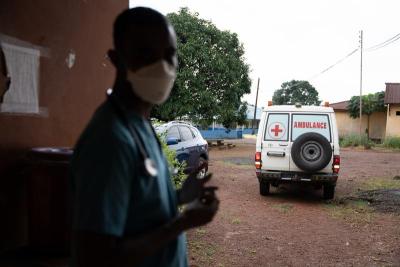 The single ambulance at Lakka Government Hospital. A health care worker is in the foreground.