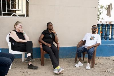 PIH CEO Dr. Sheila Davis (left) and PIH Sierra Leone Executive Director Vicky Reed (center) during a community health worker's visit with Aiah Fornah Yofari (right) in Kono District, Sierra Leone on January 19, 2024.