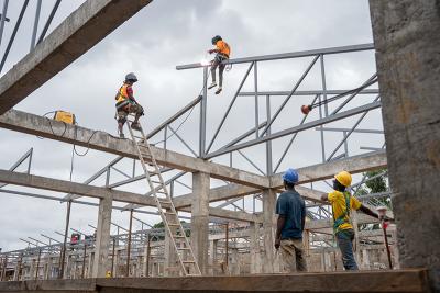 Construction workers build the North Ward of the Maternal Center of Excellence (MCOE).