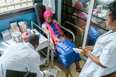 Kumba (center) and Sia’s uncle Ibrahim (not pictured) donate blood at KGH’s blood bank.
