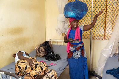 Sia’s mother, Kumba Mansaray, checks in on Sia and brings clothes.